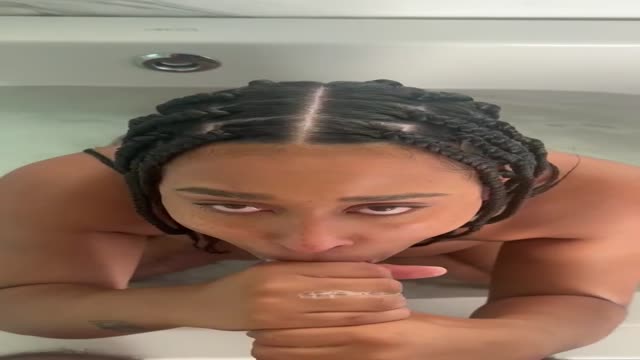 Box braids head in the tub